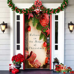 Decorative door with Christmas decorations, including garlands, ornaments, and a sign.