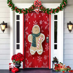 Decorative Christmas door with gingerbread man design, red background, and festive decorations.