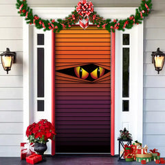 Decorative door with eye design, surrounded by Christmas decorations on a house exterior.