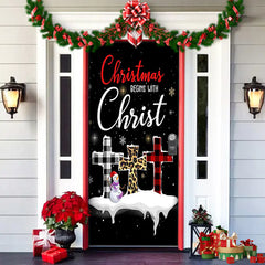 Decorative door with Christmas-themed design featuring crosses and text on a house exterior.