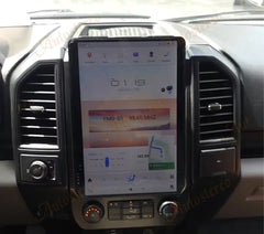 Car dashboard with a large touchscreen display and navigation system.