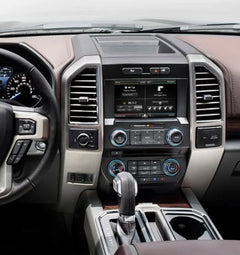 Car interior with dashboard, steering wheel, and center console.