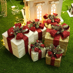 Decorative Christmas presents with red bows on a grassy background