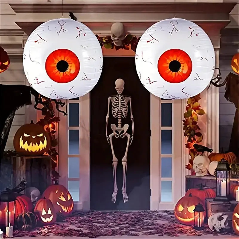 Halloween-themed decorations with eye-shaped balloons, skeletons, and pumpkins.