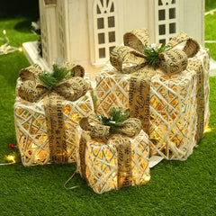 Decorative gift boxes with string lights on a grassy background