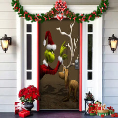Decorative door with Grinch and reindeer design, surrounded by Christmas decorations.