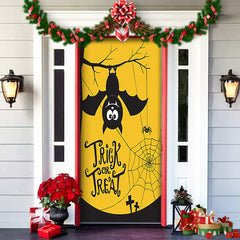 Decorative door with Halloween theme featuring a bat and 'Trick or Treat' text, surrounded by festive decorations.
